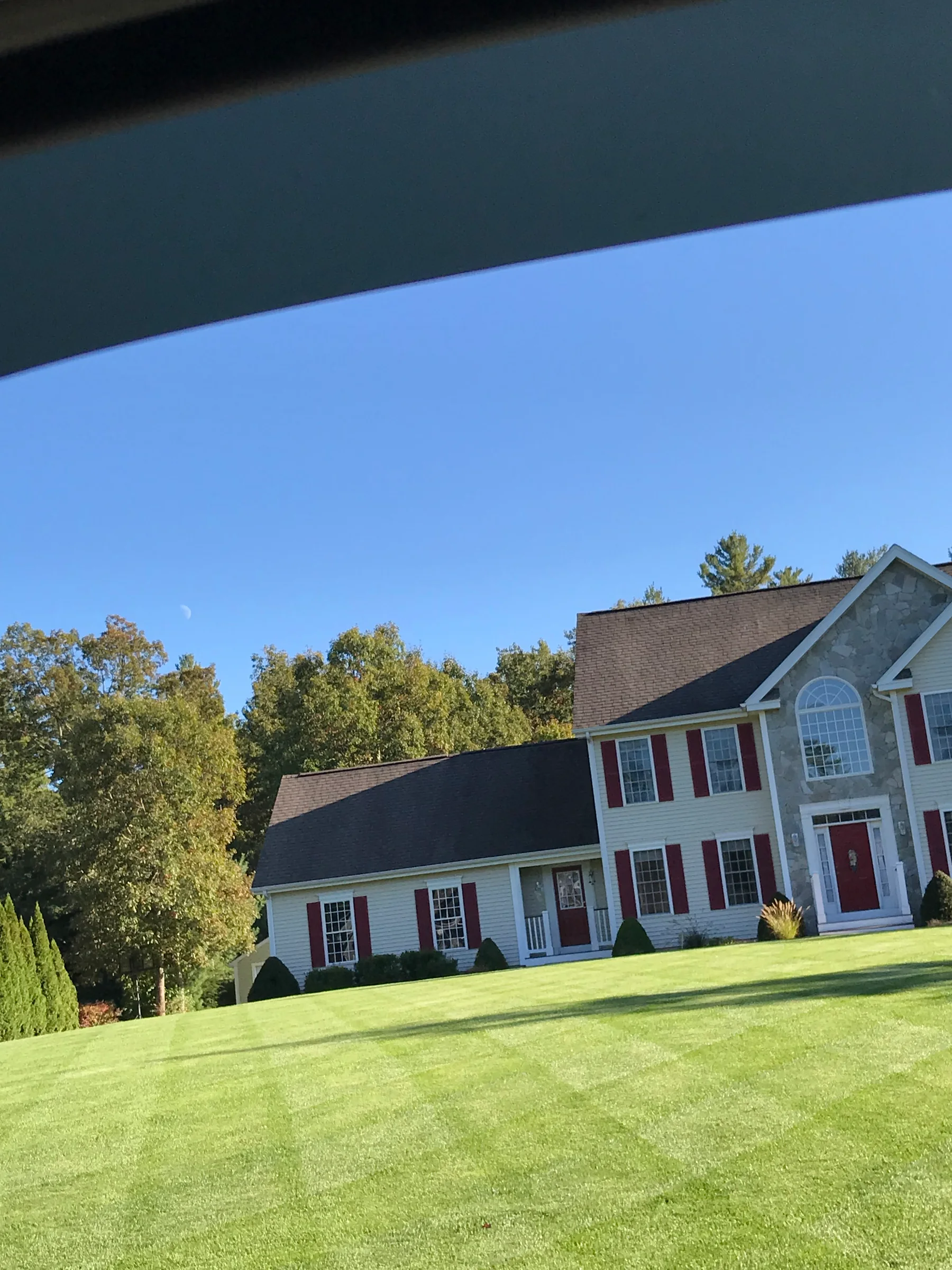 Freshly maintained residential lawn and foundation landscaping around a home
